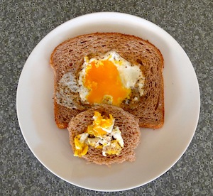 Put on plate.  Kinda gut the egg, putting the top of the soft bits onto the negative space toast piece.  